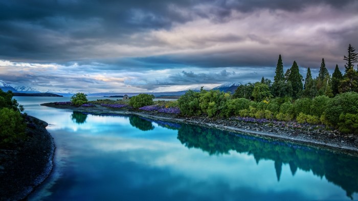 Lake Tekapo with Mountains and Cloudy Sky