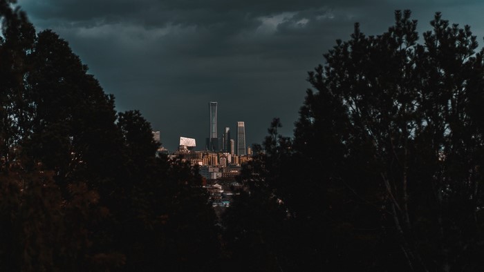 Cityscape with skyscrapers under dark clouds