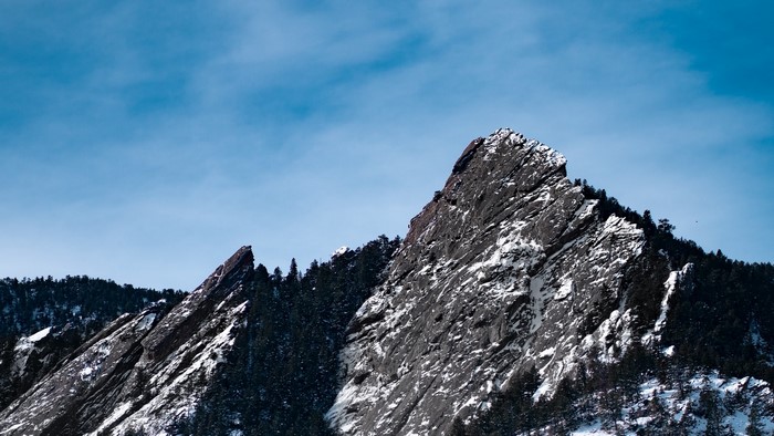 Snow-covered mountains under a blue sky