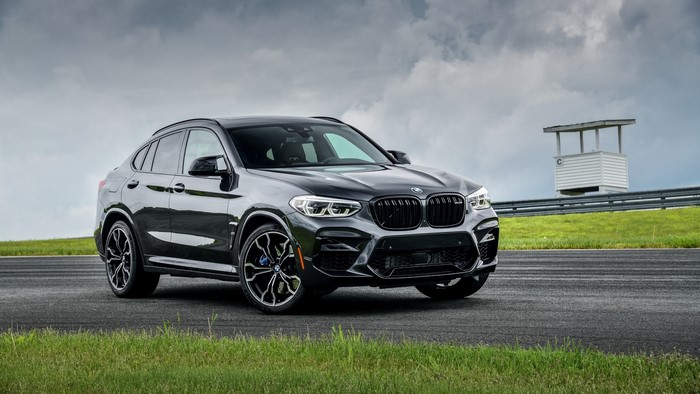 Black BMW X4M F98 on a Race Track