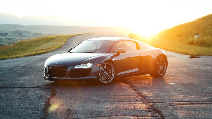 Audi R8 on a road at sunset
