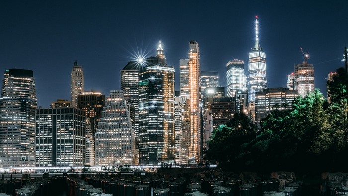 Night city skyline with illuminated skyscrapers