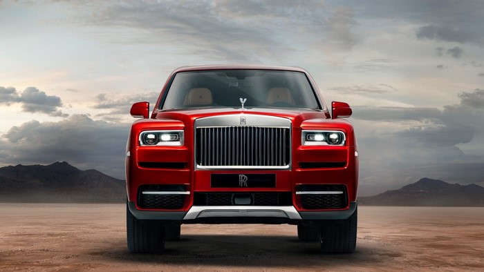 Red Rolls Royce Cullinan in a desert landscape