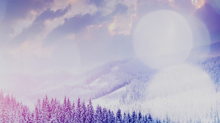 Snowy mountains with pine trees and clouds