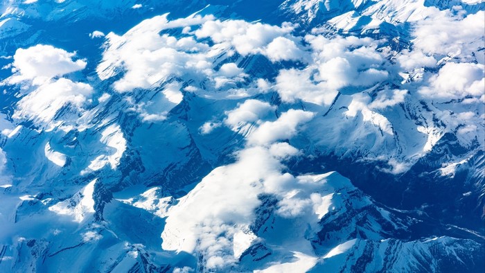 Aerial view of snow-covered mountains and clouds