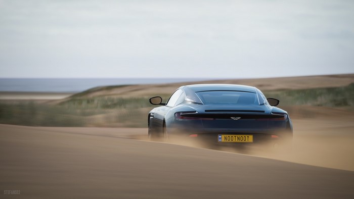 Aston Martin DB11 driving on sand dunes