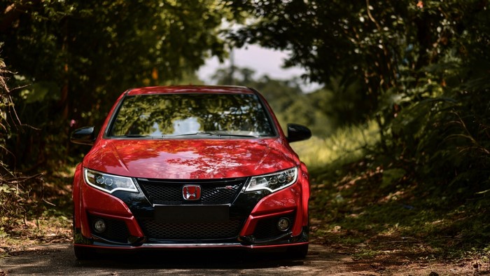 Red Honda FK2 Type R car on a dirt road
