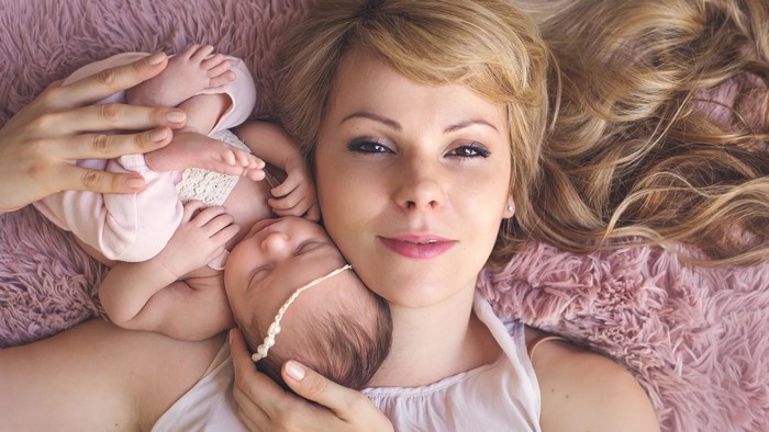 Blonde woman with two newborn babies