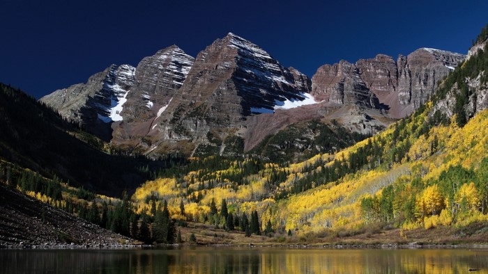 Maroon Bells mountains reflected in lake during autumn