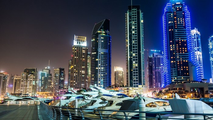 Dubai Marina skyscrapers and yachts at night