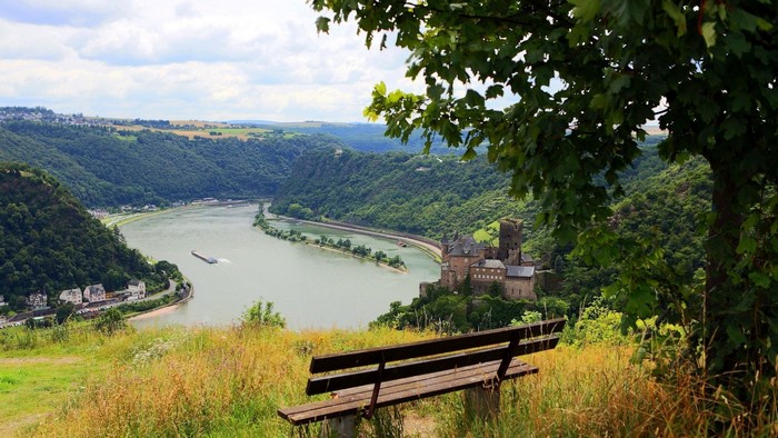 Bench overlooking a river and castle