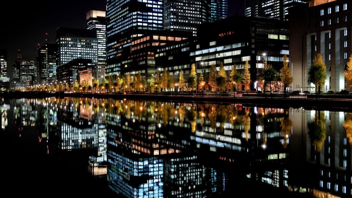 Tokyo cityscape at night with reflections in water