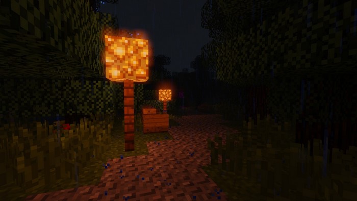 Minecraft path with glowing lamps at night