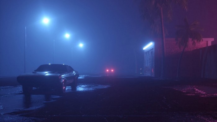 Car on a foggy street at night