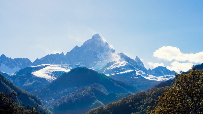 Snow-capped mountain range under a blue sky