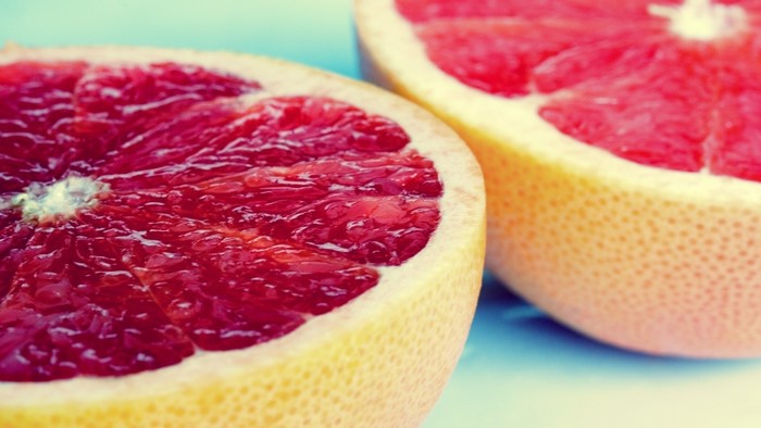 Grapefruit halves on a blue background
