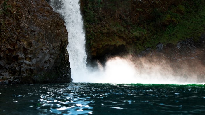 Waterfall cascading into a dark pool