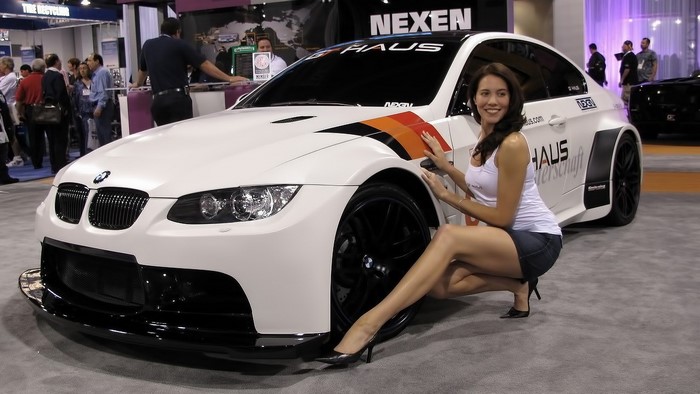 Woman posing with a white BMW M3