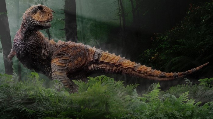 Carnotaurus dinosaur in a misty forest