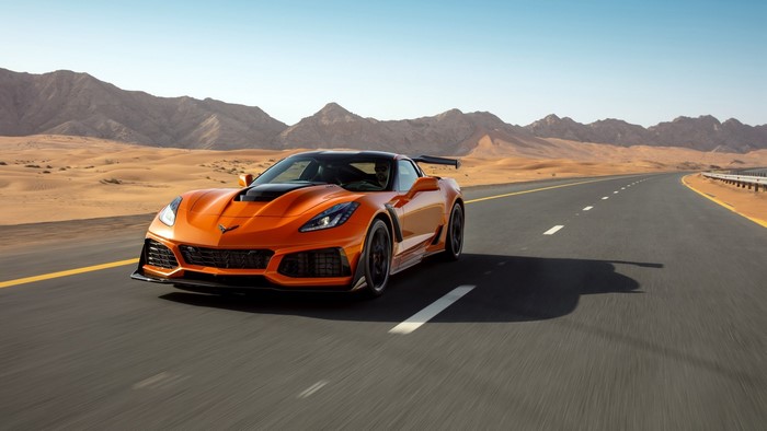 Orange Chevrolet Corvette ZR1 driving on desert road