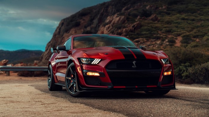 Red Ford Mustang Shelby GT500 on a road