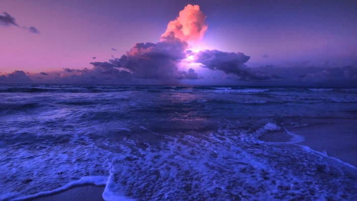 Purple sunset over ocean waves
