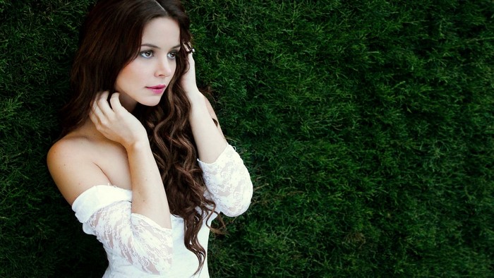 Girl in white dress on green background