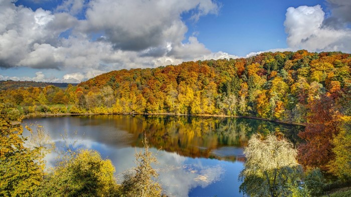 Autumn lake with colorful trees and reflection