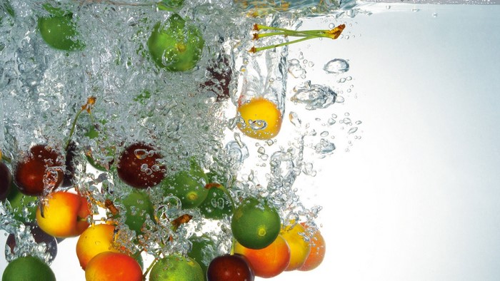 Fruits splashing into water