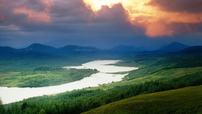 River and mountains with dramatic clouds
