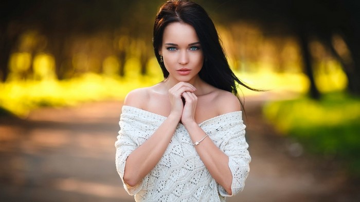 Model in white sweater outdoors