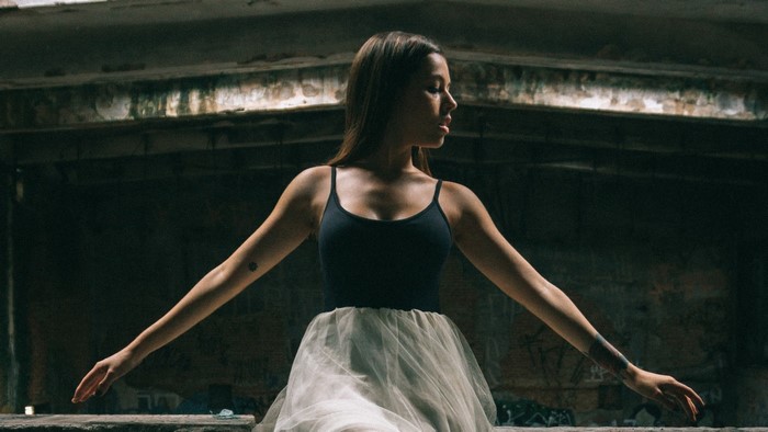Ballerina in a dark, abandoned building