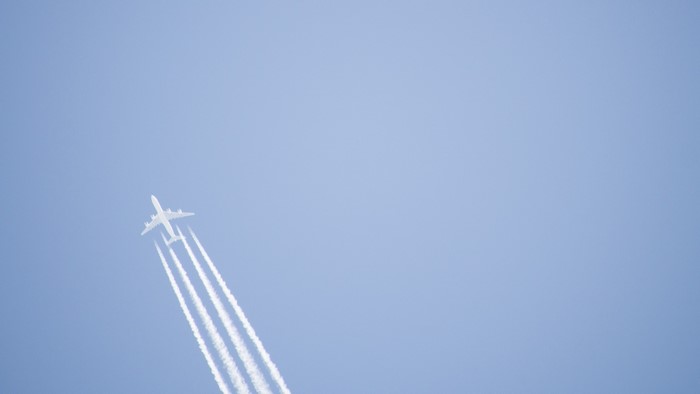 Airplane leaving contrails in a clear sky