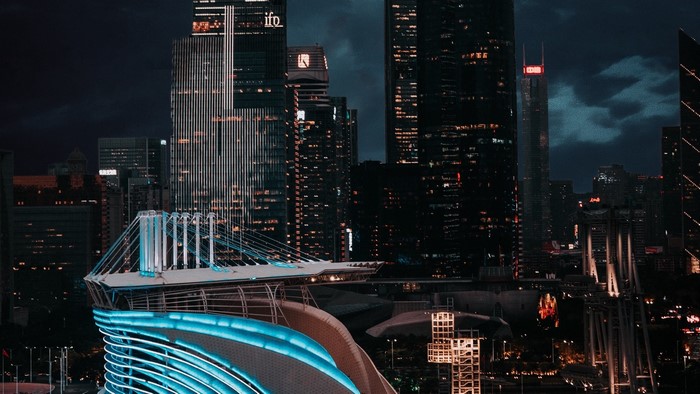Night city skyline with illuminated buildings and bridge