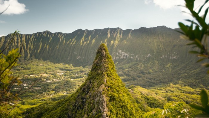 Jagged green mountain peak overlooking a valley