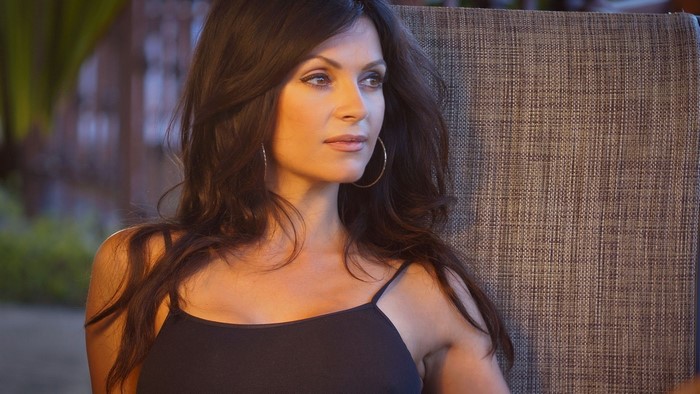 Denise Milani sitting on a chair