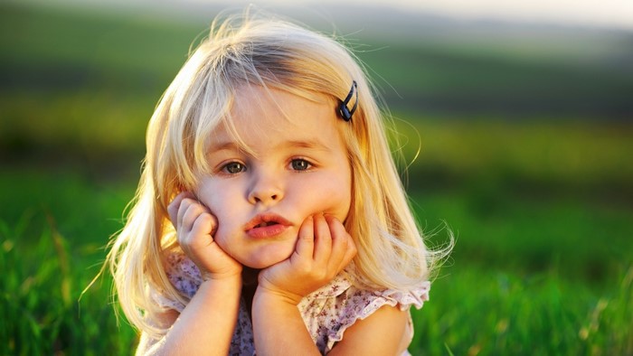 Young girl with blonde hair in a field