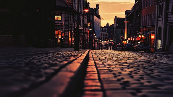 Cobblestone street in Poznan at sunset