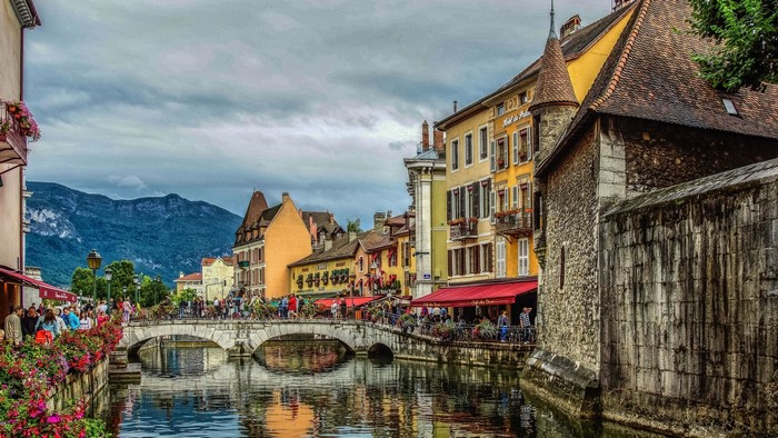 Canal in Annecy with Mountains and Buildings