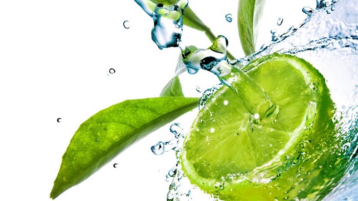 Lime slice with water splash and leaves