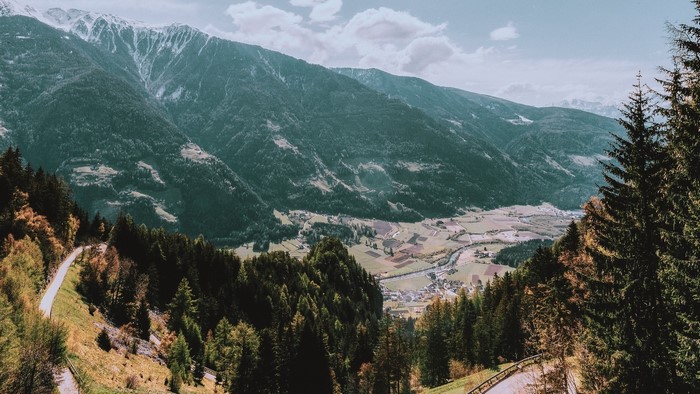 Mountain valley with snow-capped peaks and a winding road