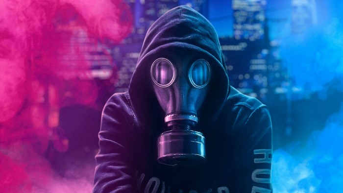Man in gas mask and hoodie with smoke