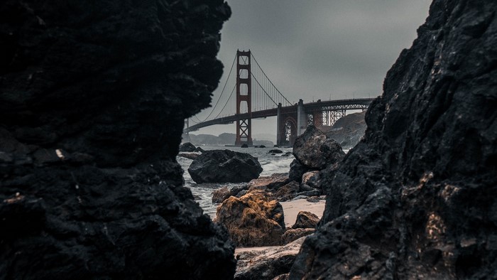 Golden Gate Bridge seen through rocks