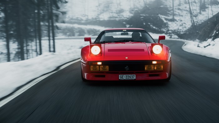 Red Ferrari 408 driving on a snowy road