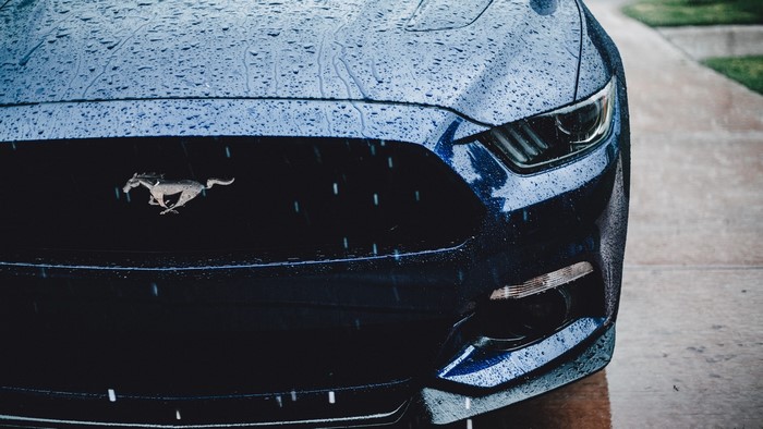 Ford Mustang with running horse emblem in the rain