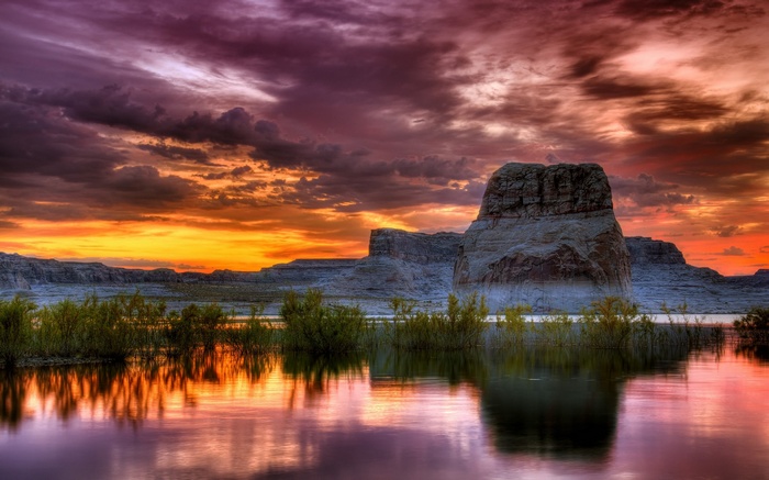 Dramatic sunset over a lake with rock formations