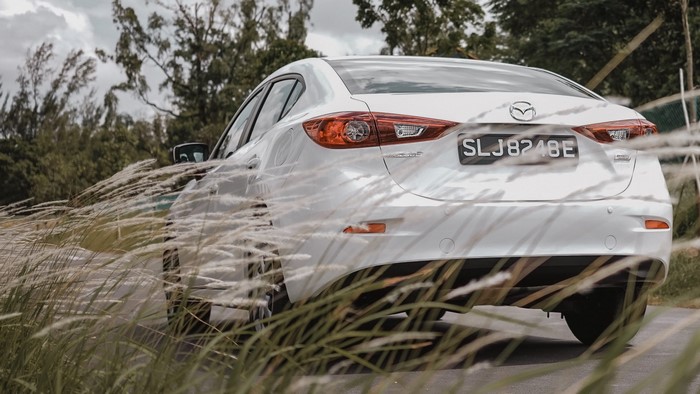 White Mazda 3 Sedan with License Plate SLJ8248E