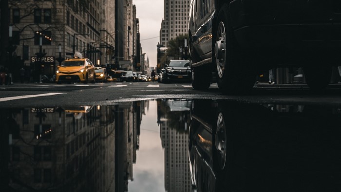 Yellow taxi cabs on a wet city street