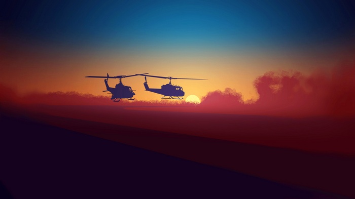 Two military helicopters at sunset