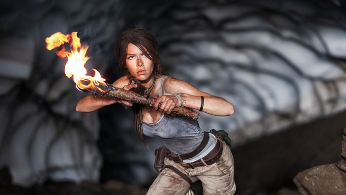 Lara Croft from Tomb Raider holding a torch